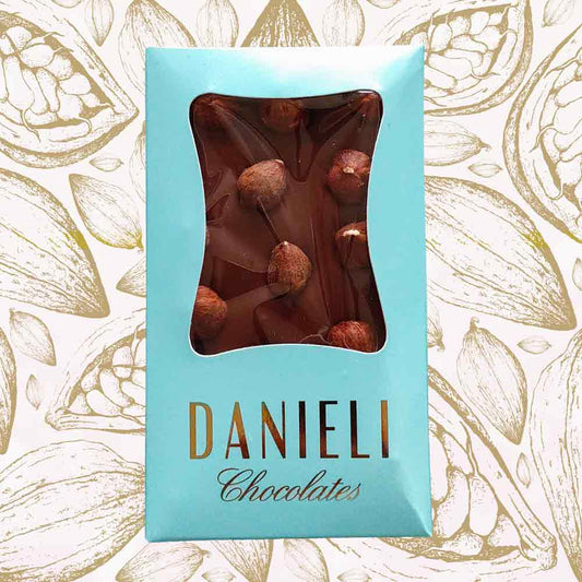 bar of danieli handmade milk chocolate hazelnut chocolate bar on a cacao pod background
