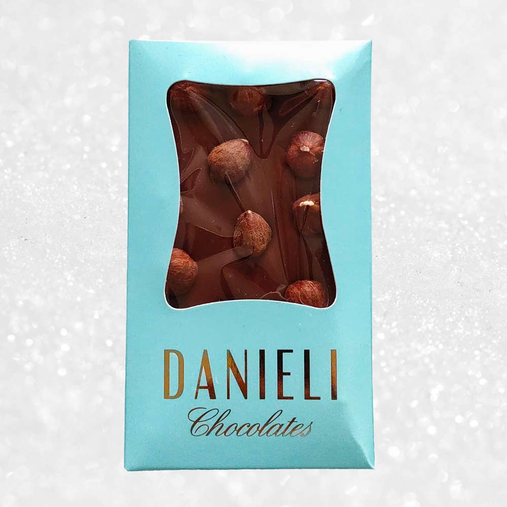 bar of danieli handmade milk chocolate hazelnut chocolate bar on a snowy background