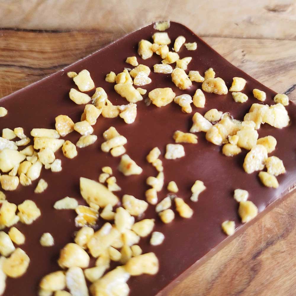 close up of Danieli milk chocolate honeycomb bar on a wooden board