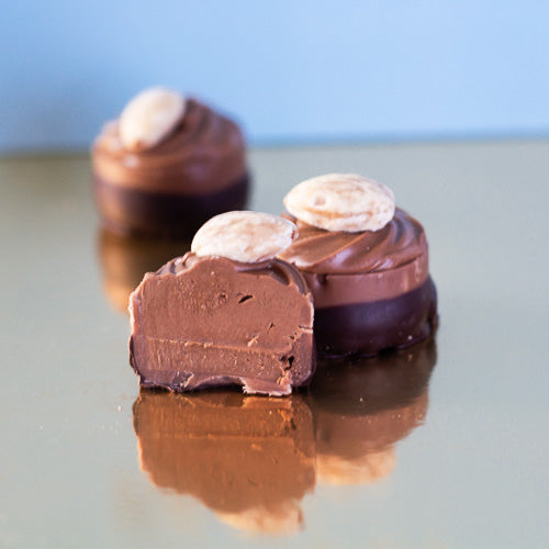 Milk chocolate praline on a gold background