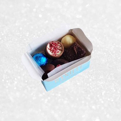 Assorted colorful chocolates in a box on a white background