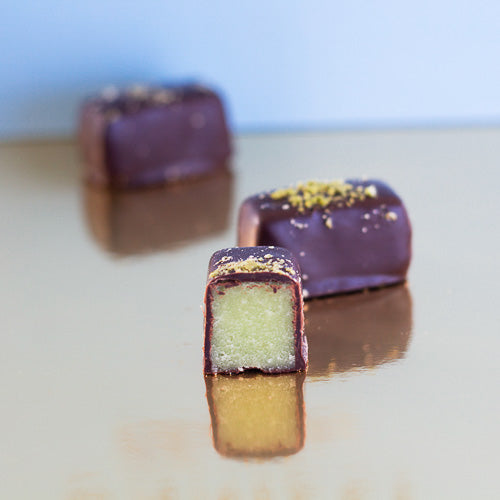 pistachio dark chocolate marzipan on a gold background