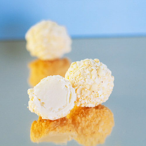 Sicilian lemon white chocolate truffle on a gold background