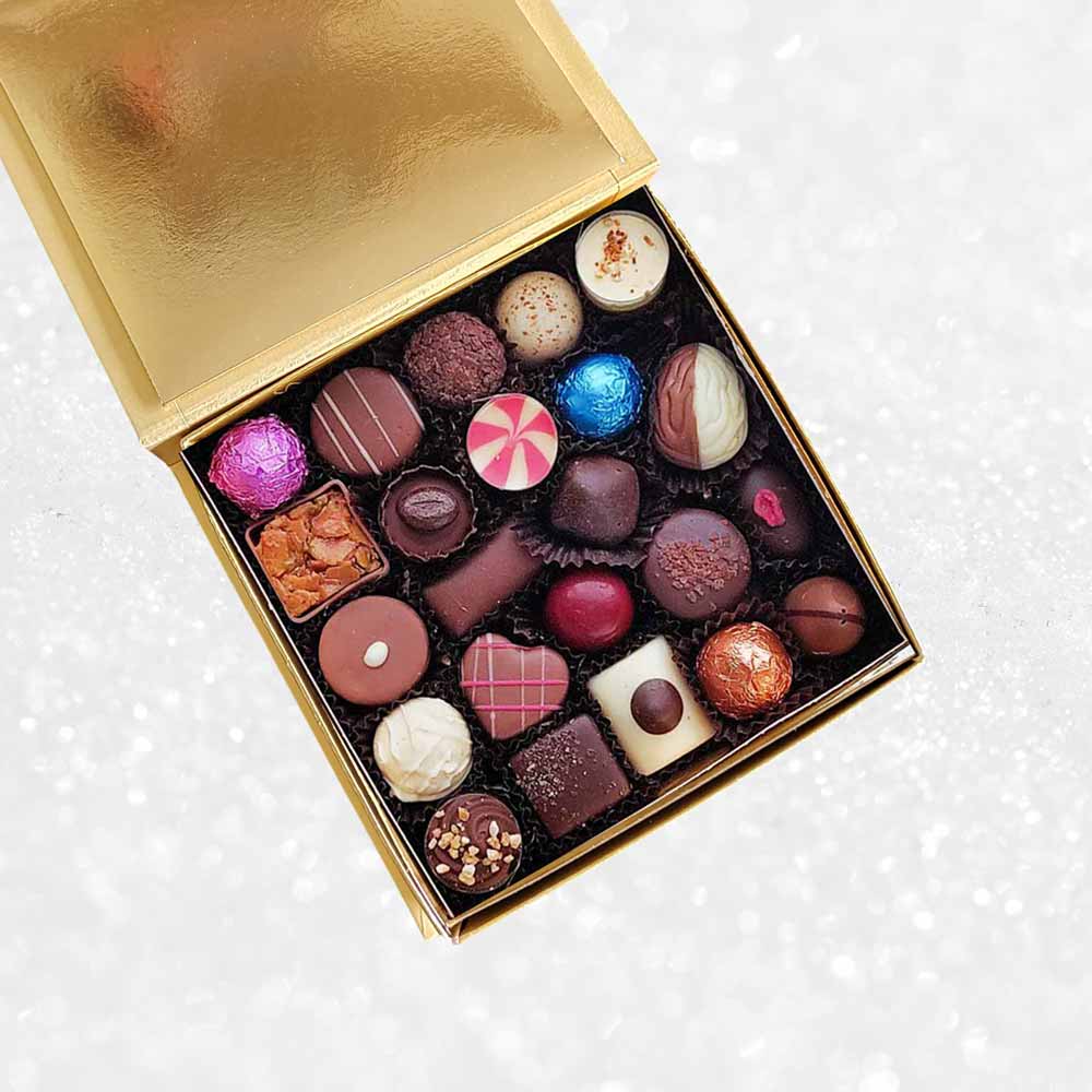 inside view of a Danieli chocolates for Christmas luxury gold box on a snowy background