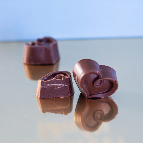 solid milk chocolate heart on a gold background