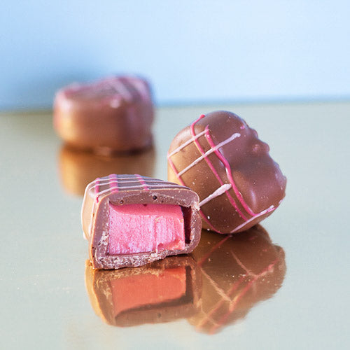 milk chocolate strawberry cream heart on a gold background