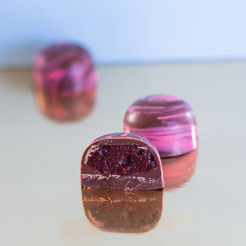 Milk chocolate strawberry centre on a gold background