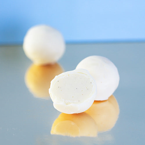 Vanilla white chocolate truffle on a gold background