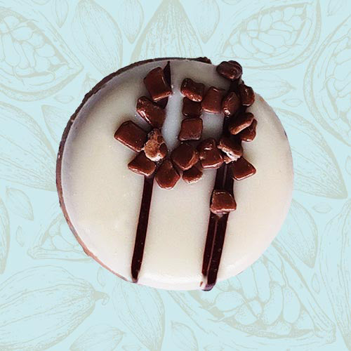 Danieli individual chocolates white chocolate caramel fudge on a blue and brown cacao pod background