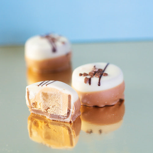 white chocolate caramel fudge on a gold background